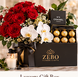 Luxury gift box with red roses, white orchids, chocolates, and a candle